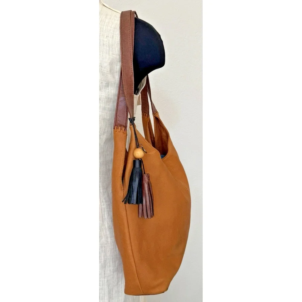 The Sak Women's Huntley‎ Leather Hobo Bag Metro Sling Pebbled Tan with Tassel